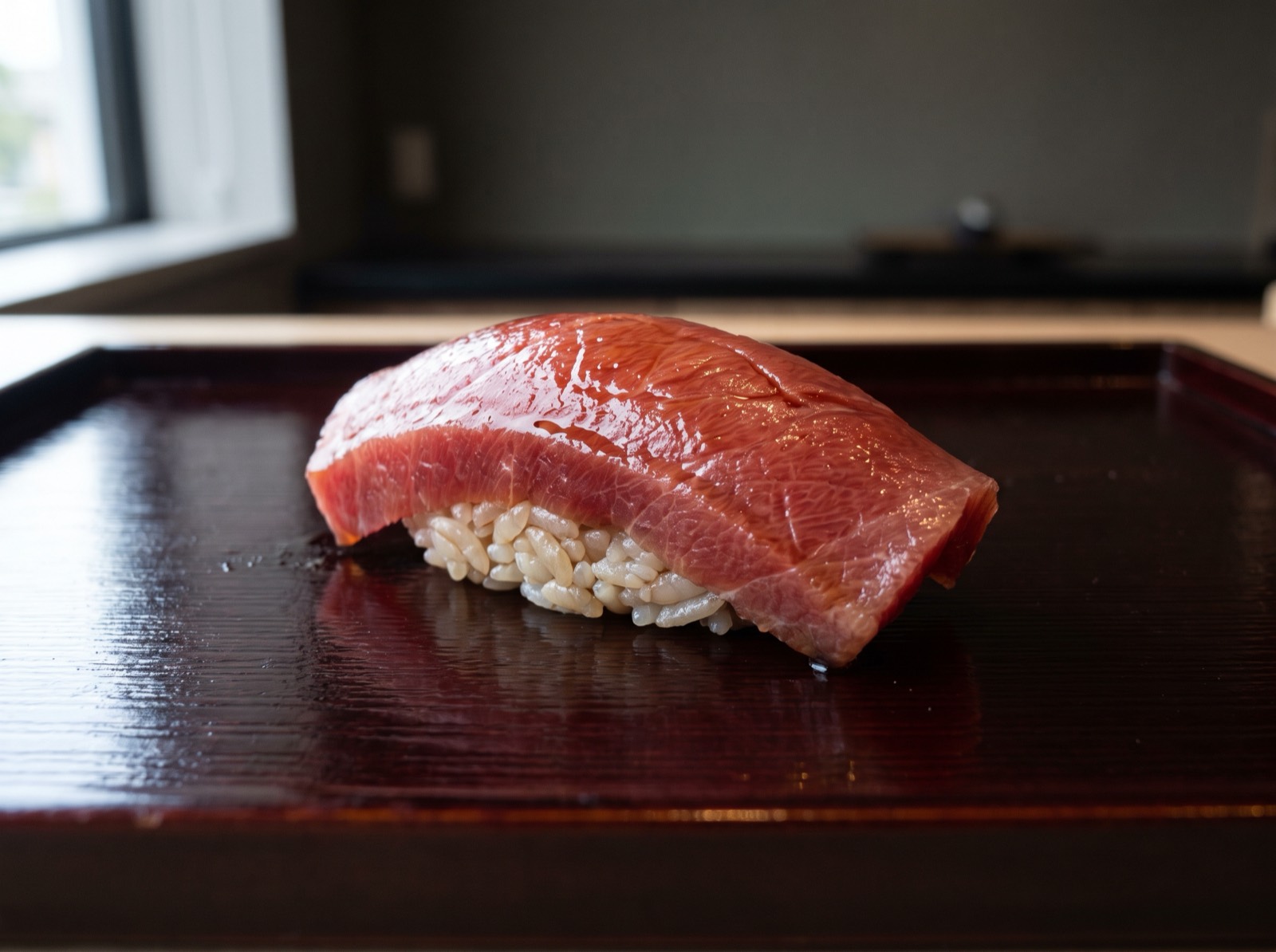 Akami nigiri, lean tuna brushed with nikiri.