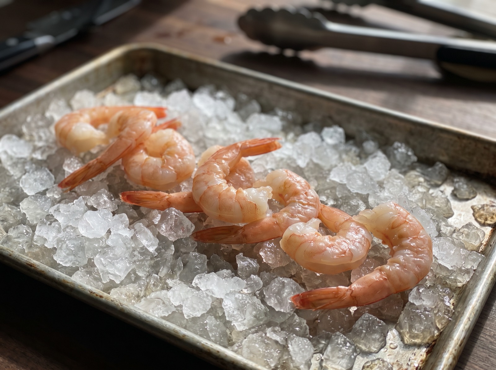 Amaebi, freshly peeled and resting on ice in a prep tray.
