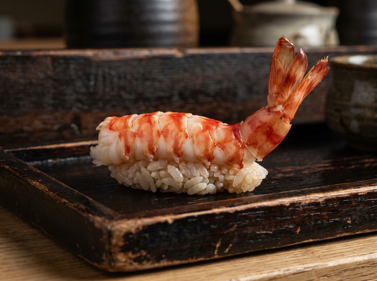 Kuruma prawn nigiri, butterflied to show its banded stripes.