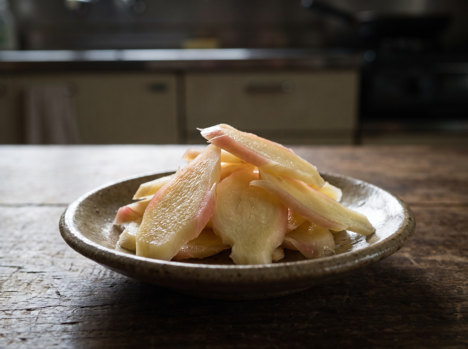 Pickled ginger, sliced thin, in a small dish.
