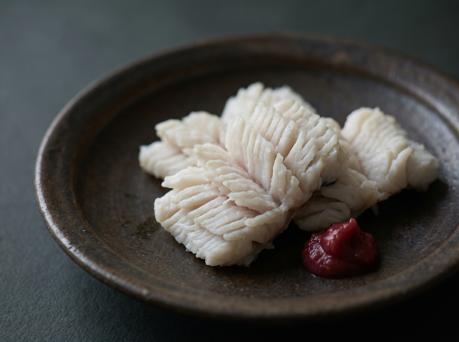 Blanched pike conger, the bones cut and the flesh opened out.