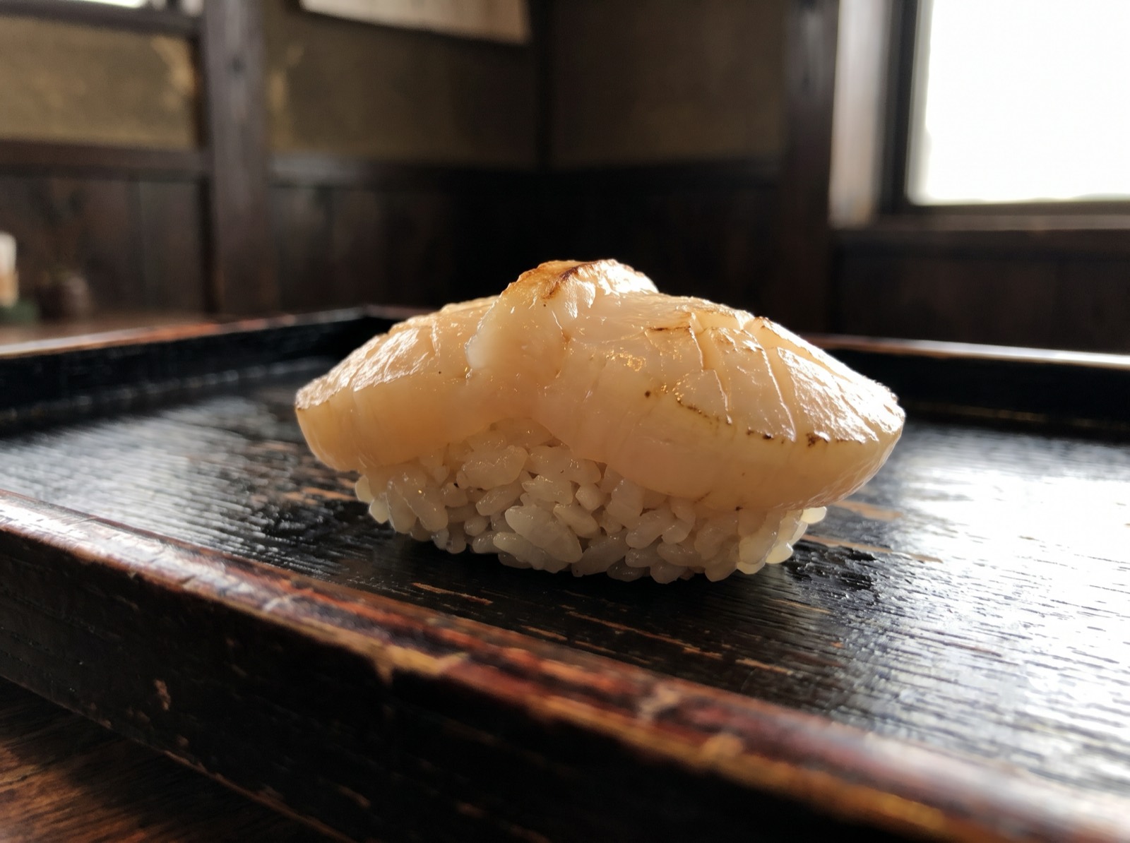 Scallop nigiri, cut thick with a raw centre.