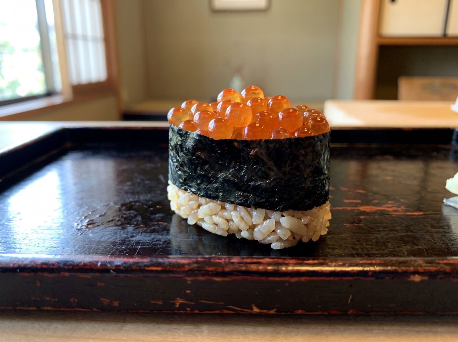 Ikura gunkan, salmon roe held in a band of nori.