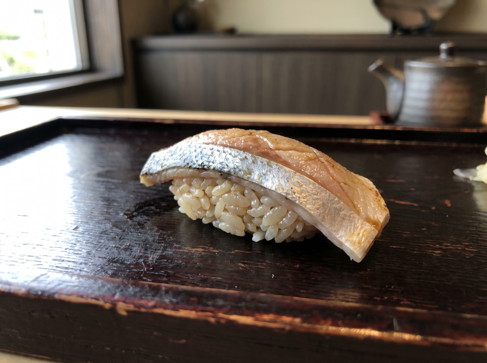 Isaki nigiri with a silver line of skin left on.