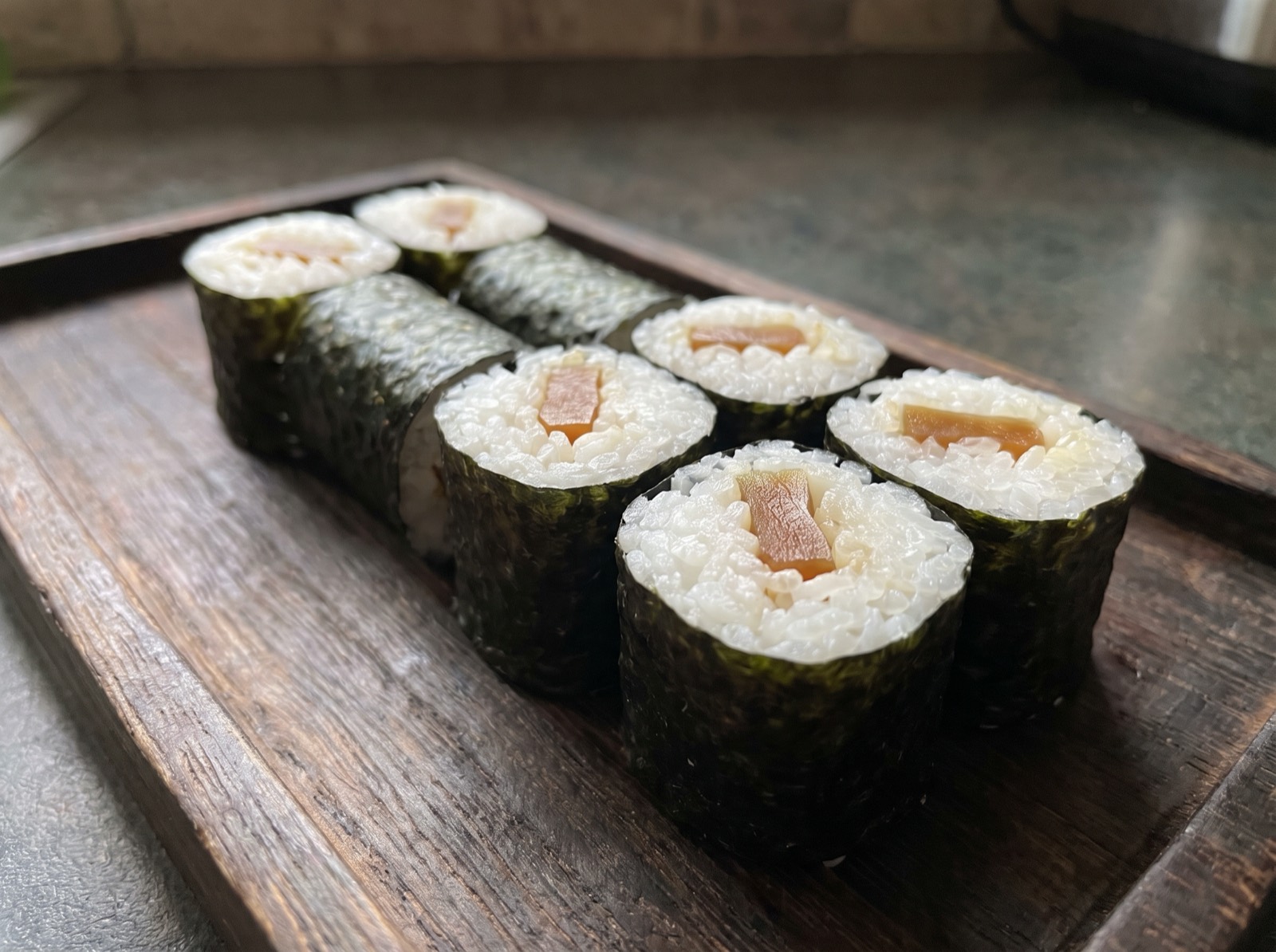 Kanpyo maki, cut into six, showing the gourd strip inside.