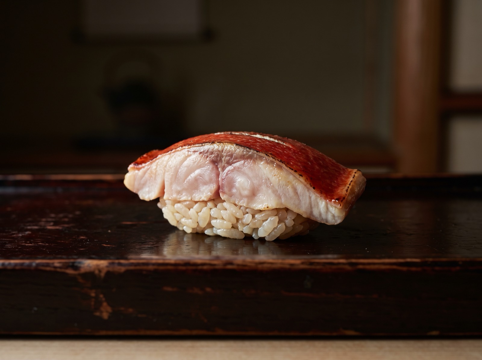 Nodoguro nigiri, lightly seared, its fat-clouded white flesh the subject.