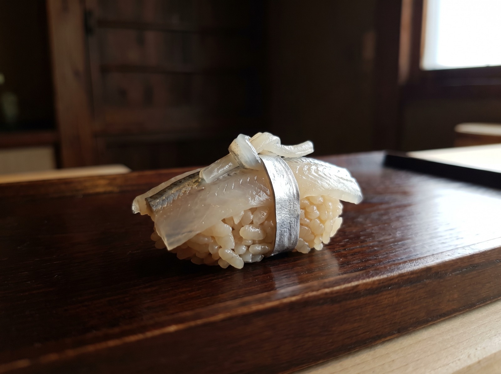 Halfbeak nigiri, thin enough to be translucent.