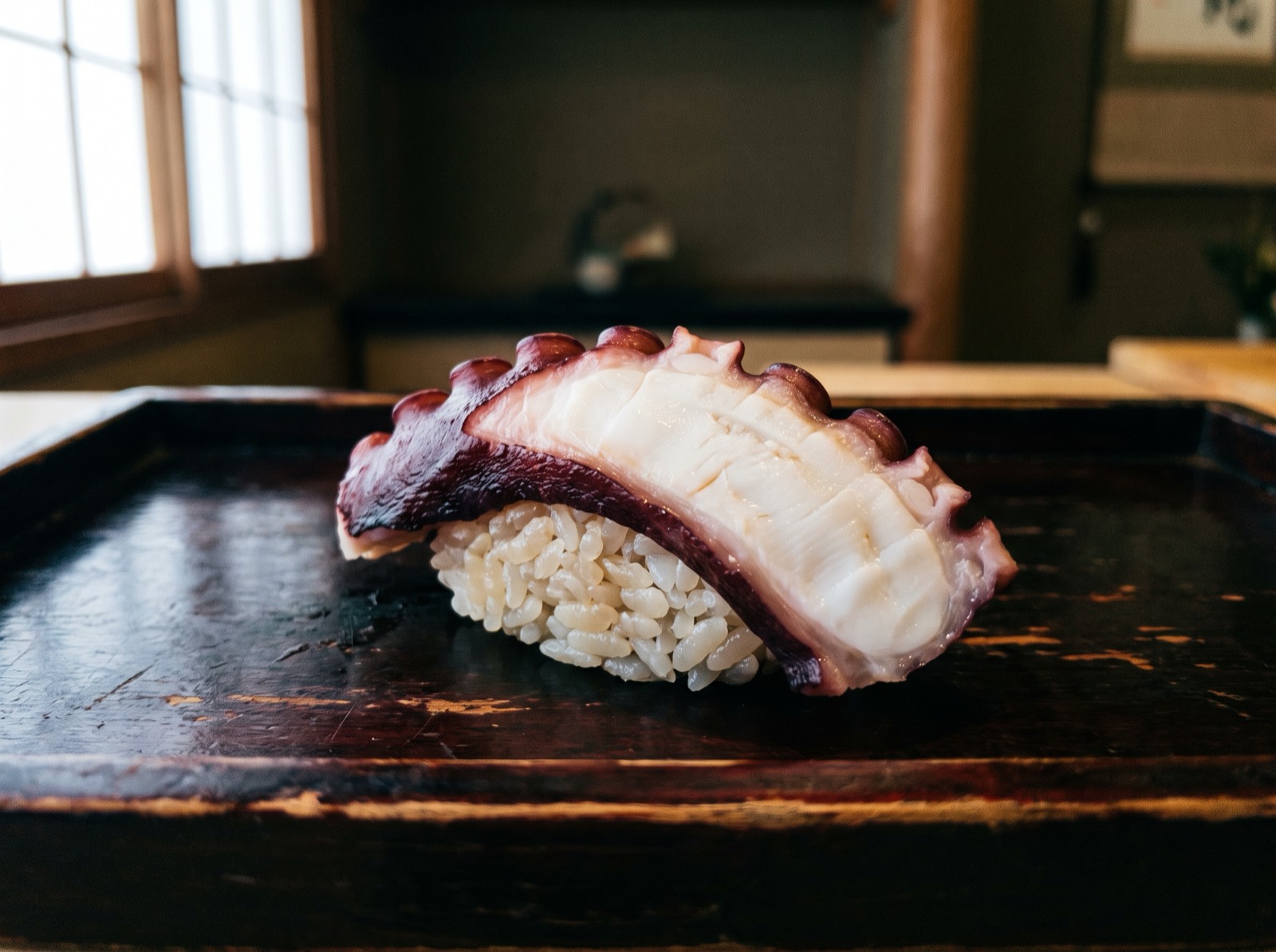 Octopus nigiri, cut on the diagonal through the tentacle.