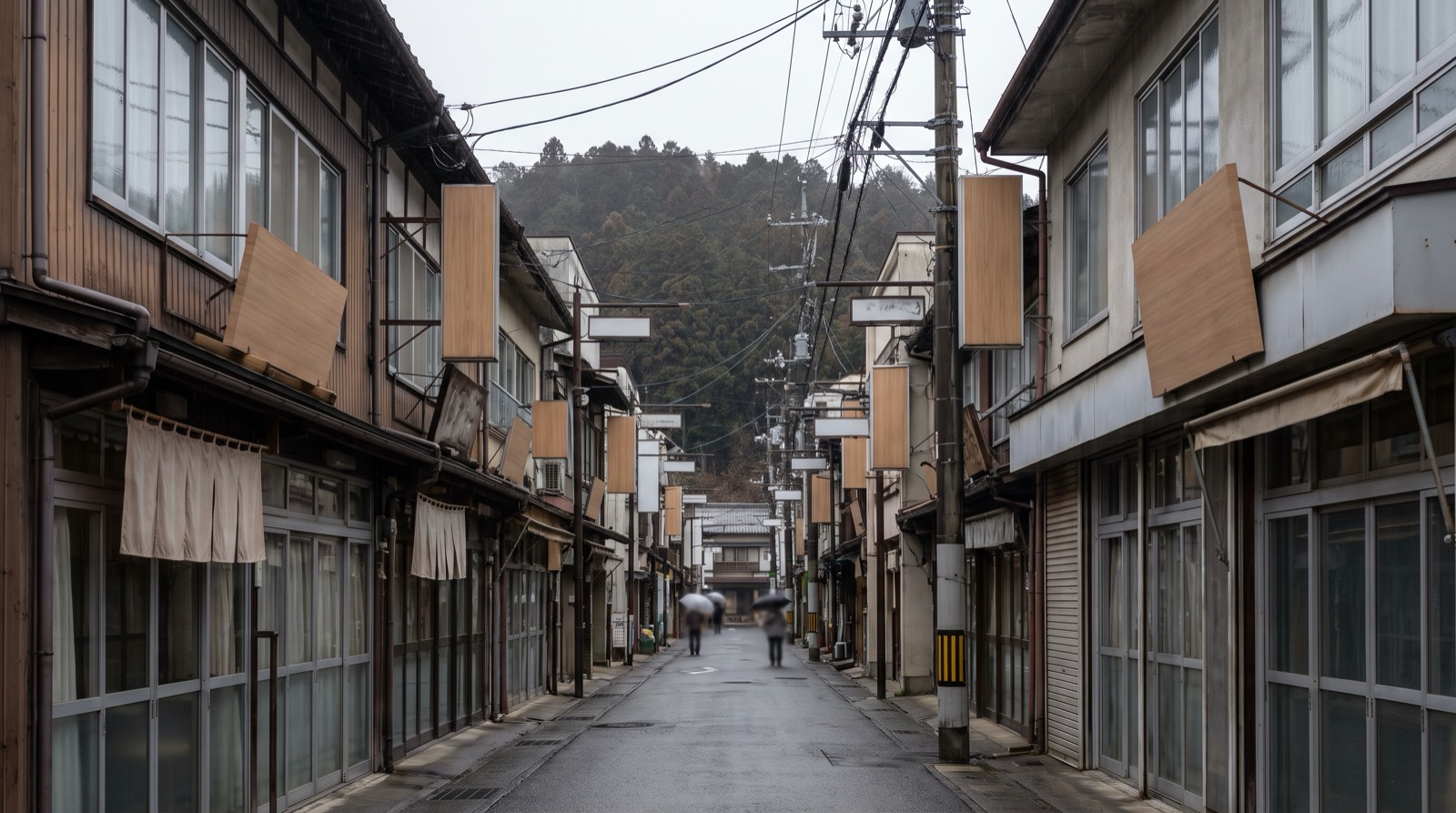 A local shopping street seen down its length, shopfronts crowding both sides.