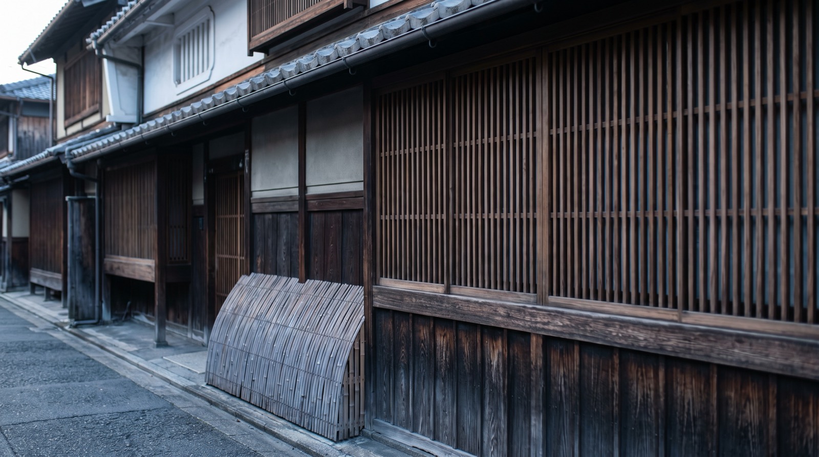 The lattice front of an old Japanese townhouse at first light.