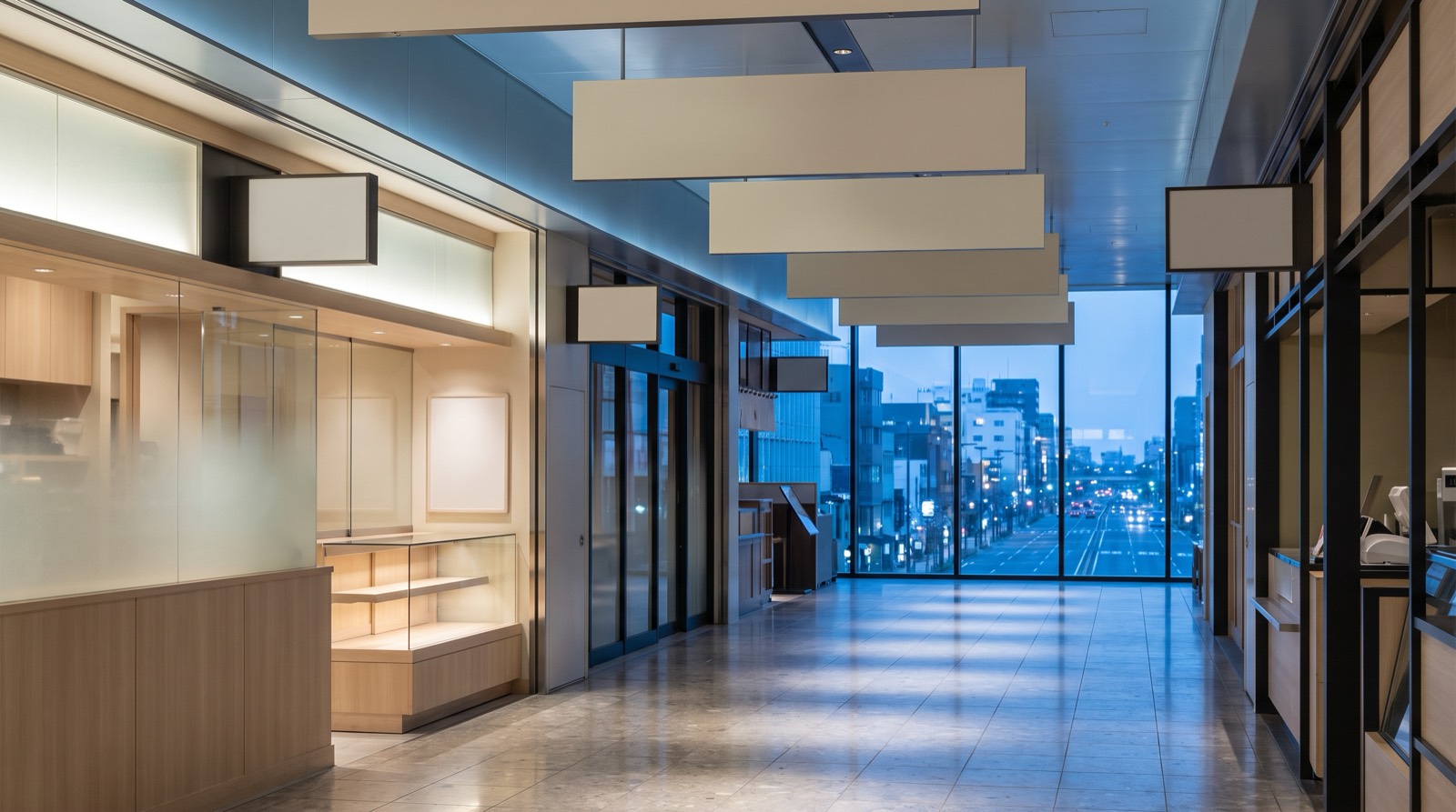 A department-store dining passage, the street below visible through its window wall.